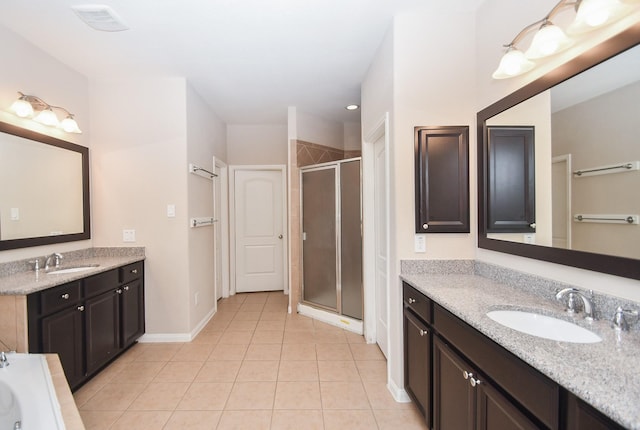 full bathroom with two vanities, tile patterned floors, a shower stall, and a sink