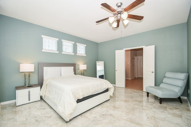 bedroom featuring baseboards, ceiling fan, and marble finish floor