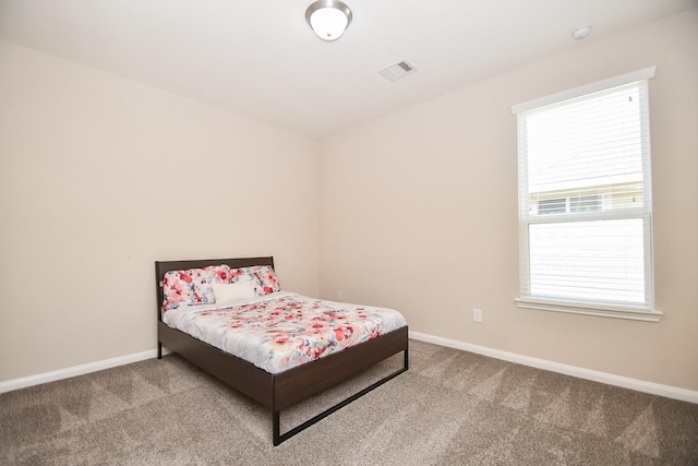 bedroom with baseboards, multiple windows, carpet flooring, and visible vents