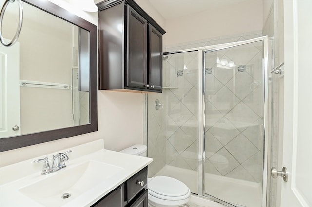 full bath with vanity, a stall shower, and toilet