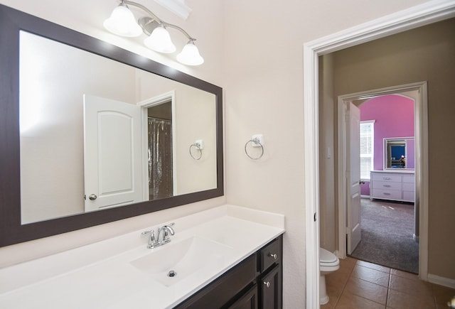 full bathroom with vanity, tile patterned flooring, and toilet