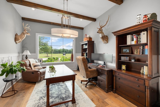 home office featuring a decorative wall, beamed ceiling, wainscoting, and light wood finished floors