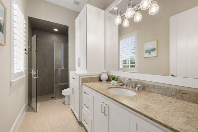 bathroom with toilet, visible vents, a shower stall, and vanity