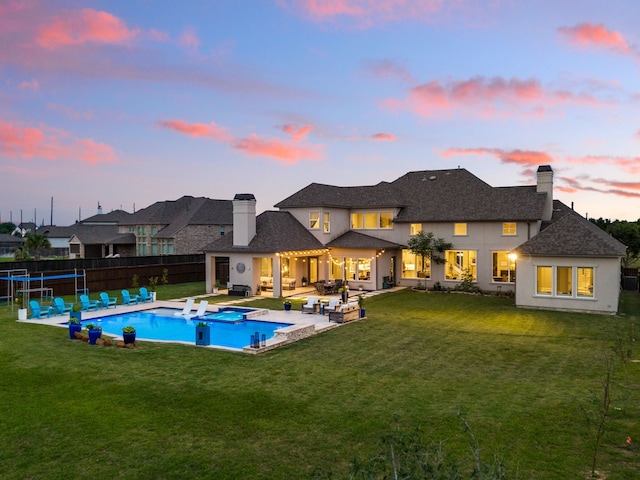view of swimming pool with a lawn, a patio, outdoor lounge area, and a fenced backyard