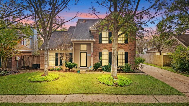 2021 Caravel Dr, League City, TX 77573 - traditional home with fence, a lawn, driveway, and brick siding