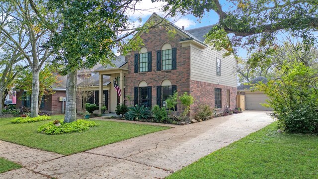 2021 Caravel Dr, League City, TX 77573 - traditional-style home with an outdoor structure, a front yard, driveway, and brick siding