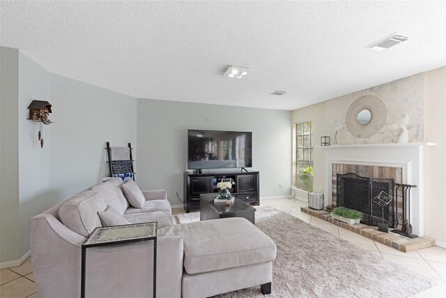 2021 Caravel Dr, League City, TX 77573 - tiled living room featuring a fireplace, a textured ceiling, and visible vents