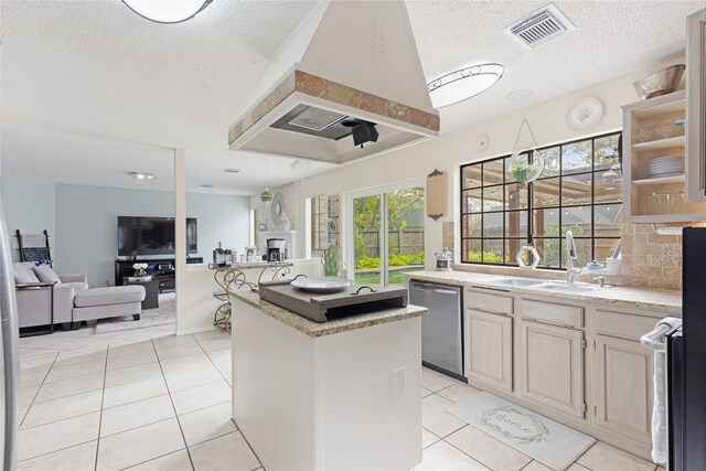 2021 Caravel Dr, League City, TX 77573 - kitchen featuring a kitchen island, a textured ceiling, visible vents, stainless steel dishwasher, and a sink