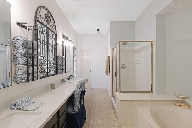 2021 Caravel Dr, League City, TX 77573 - bathroom featuring double vanity, baseboards, a bath, a shower stall, and a sink