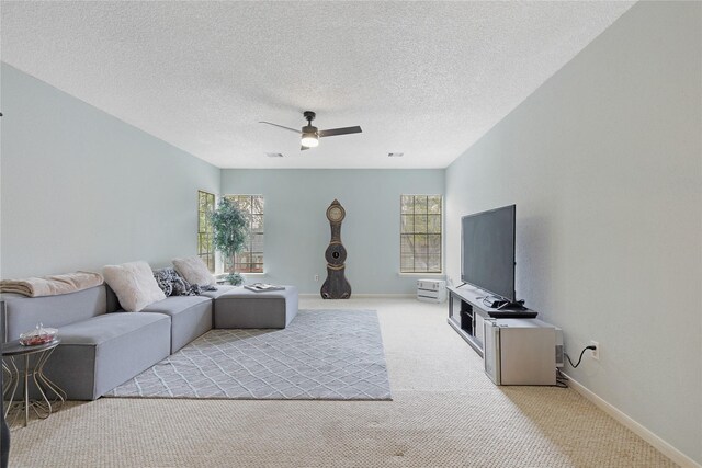 2021 Caravel Dr, League City, TX 77573 - living room with visible vents, baseboards, light colored carpet, a textured ceiling, and a ceiling fan