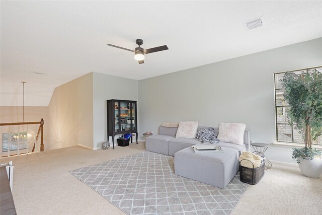 2021 Caravel Dr, League City, TX 77573 - living room featuring visible vents, baseboards, light colored carpet, and ceiling fan with notable chandelier