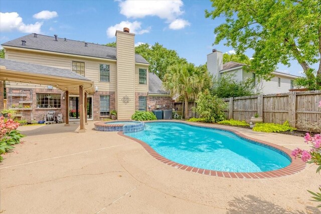 2021 Caravel Dr, League City, TX 77573 - view of pool with a patio, a pool with connected hot tub, and a fenced backyard