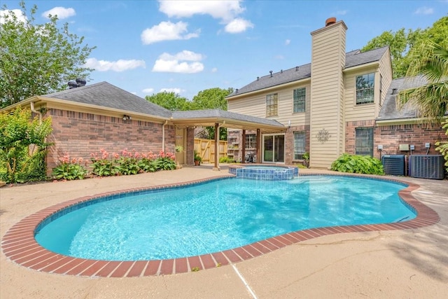 2021 Caravel Dr, League City, TX 77573 - view of swimming pool featuring central air condition unit, a pool with connected hot tub, and fence