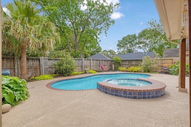 2021 Caravel Dr, League City, TX 77573 - view of pool featuring a fenced backyard, a pool with connected hot tub, and a patio area