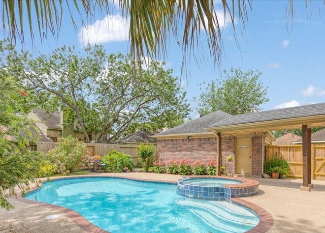 2021 Caravel Dr, League City, TX 77573 - view of swimming pool featuring a fenced backyard, a patio, and a pool with connected hot tub