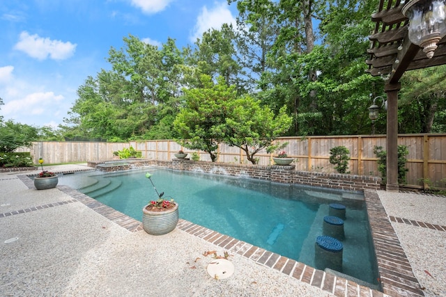 view of swimming pool featuring a patio, a pool with connected hot tub, and a fenced backyard