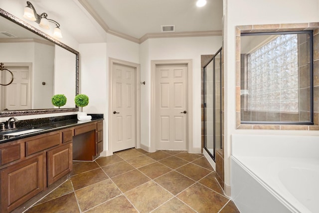 bathroom with crown molding, a shower stall, a garden tub, and vanity