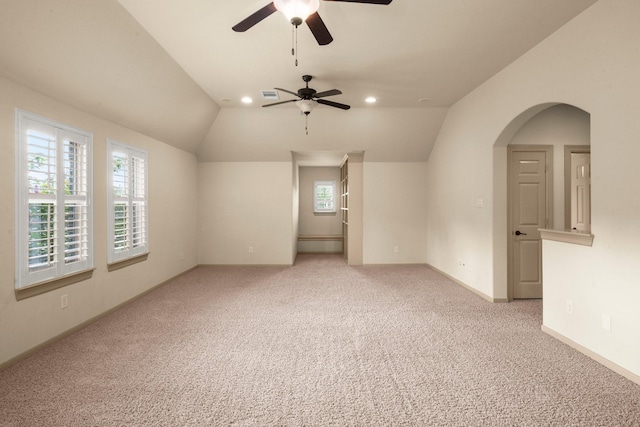 interior space featuring light carpet, a ceiling fan, baseboards, recessed lighting, and vaulted ceiling