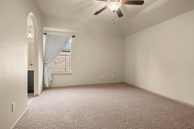 empty room featuring a ceiling fan, baseboards, and carpet