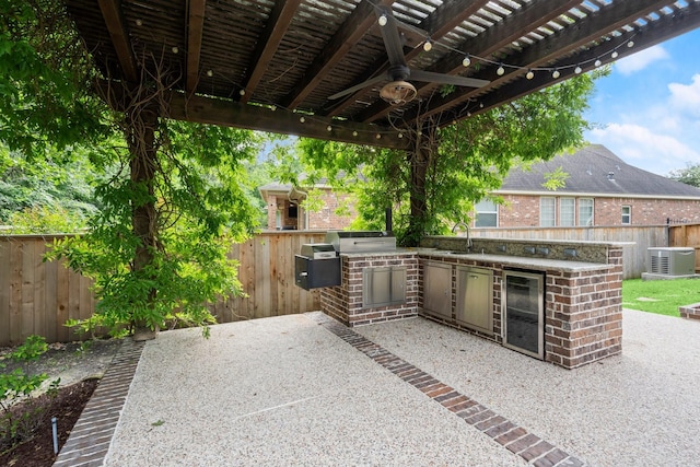 view of patio featuring a sink, area for grilling, a fenced backyard, central AC unit, and a ceiling fan