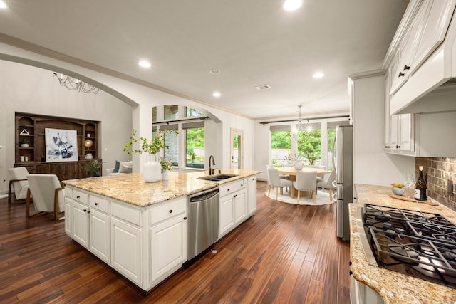 kitchen featuring a sink, premium range hood, stainless steel appliances, recessed lighting, and white cabinetry