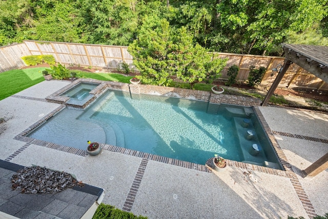 view of pool with a fenced backyard, a pool with connected hot tub, and a patio area