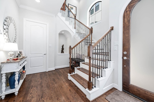4707 Jackson St, Houston, TX 77004 - foyer with arched walkways, wood finished floors, baseboards, stairway, and crown molding