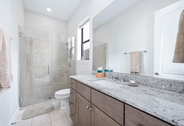 4707 Jackson St, Houston, TX 77004 - full bathroom with vanity, a stall shower, toilet, tile patterned flooring, and baseboards