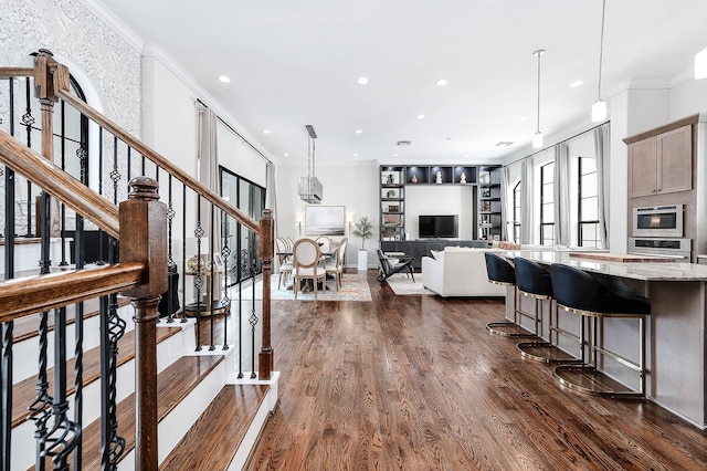 4707 Jackson St, Houston, TX 77004 - kitchen featuring crown molding, healthy amount of natural light, recessed lighting, stainless steel oven, and dark wood-style flooring