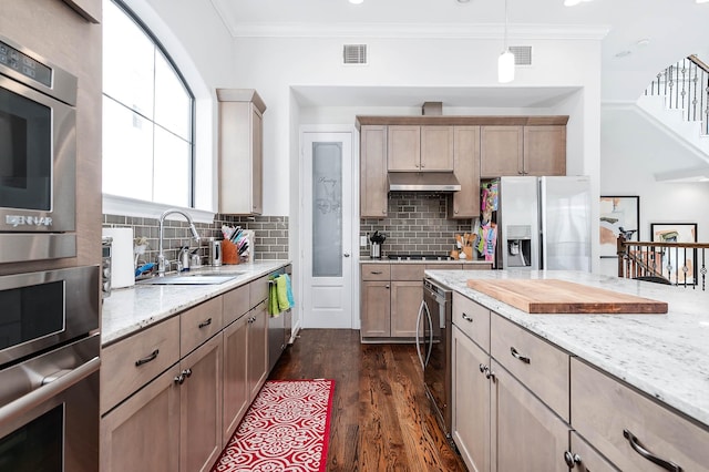 kitchen with beverage cooler, under cabinet range hood, light stone counters, a sink, and appliances with stainless steel finishes