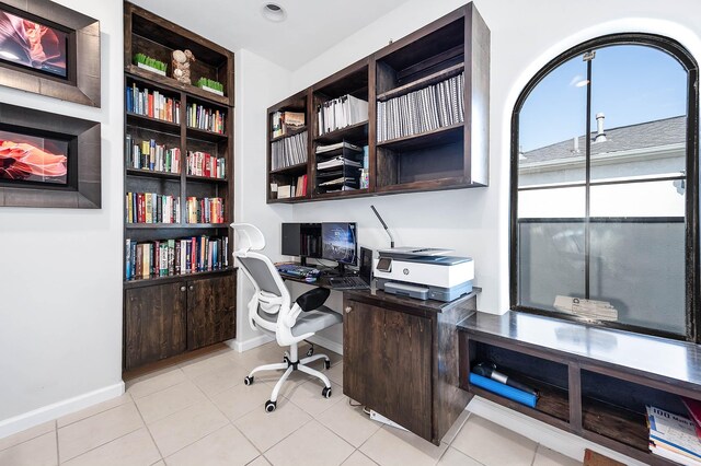 4707 Jackson St, Houston, TX 77004 - office with built in study area, baseboards, built in shelves, and light tile patterned floors