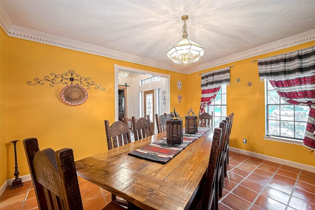 tiled dining space featuring an inviting chandelier, baseboards, and ornamental molding