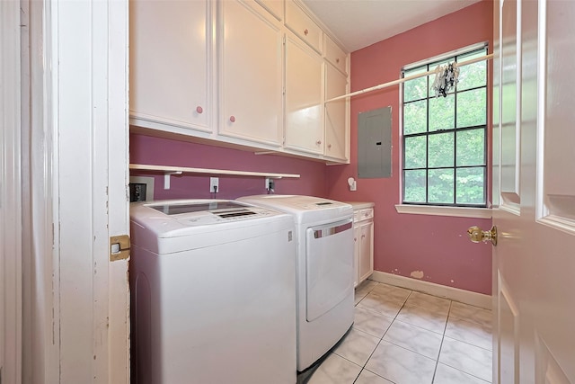 clothes washing area with electric panel, cabinet space, light tile patterned floors, baseboards, and washer and dryer