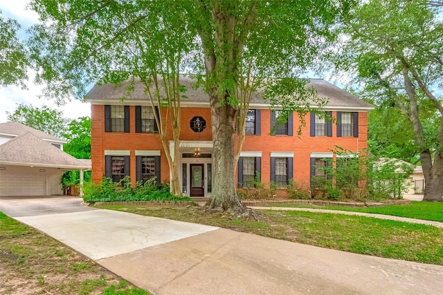 view of front of home featuring brick siding and driveway