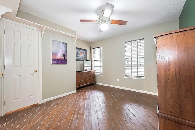unfurnished bedroom with wood-type flooring, baseboards, and ceiling fan