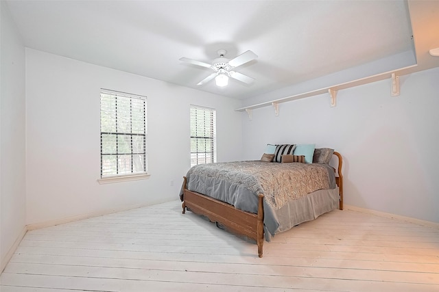 bedroom featuring wood-type flooring and a ceiling fan