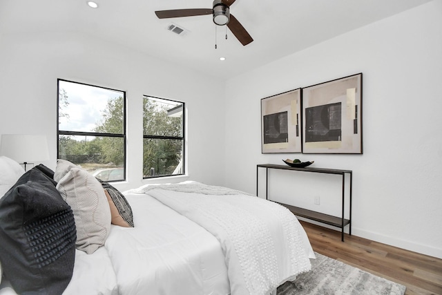 bedroom with recessed lighting, ceiling fan, visible vents, and wood finished floors