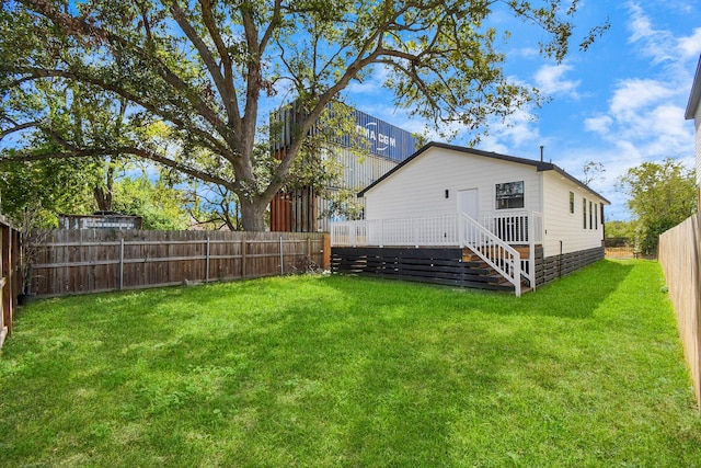 back of house with a lawn, a fenced backyard, and a deck