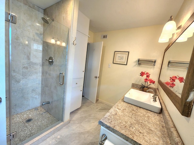 bathroom with vanity, a stall shower, marble finish floor, and visible vents