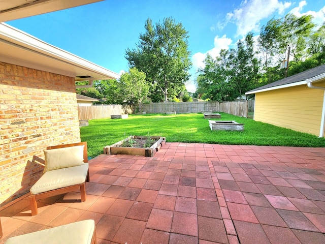 view of patio with a fenced backyard and a fire pit