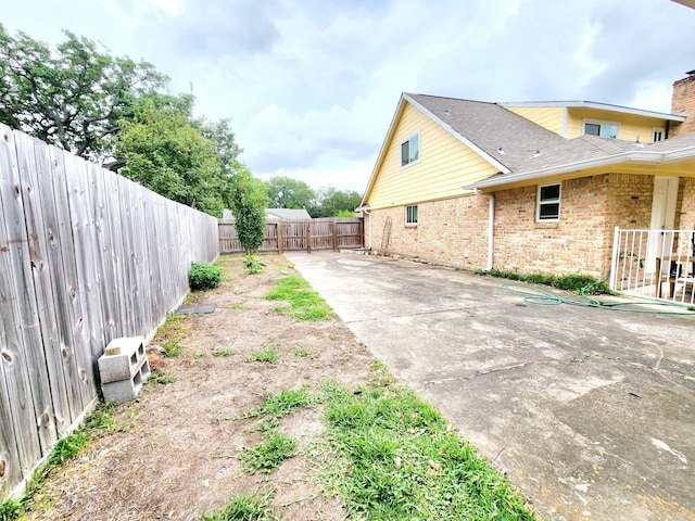 view of yard featuring a fenced backyard and a patio area