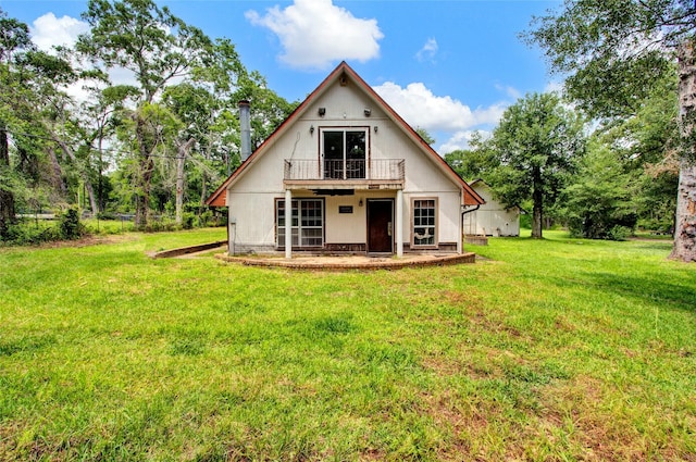 back of property featuring a yard and a deck