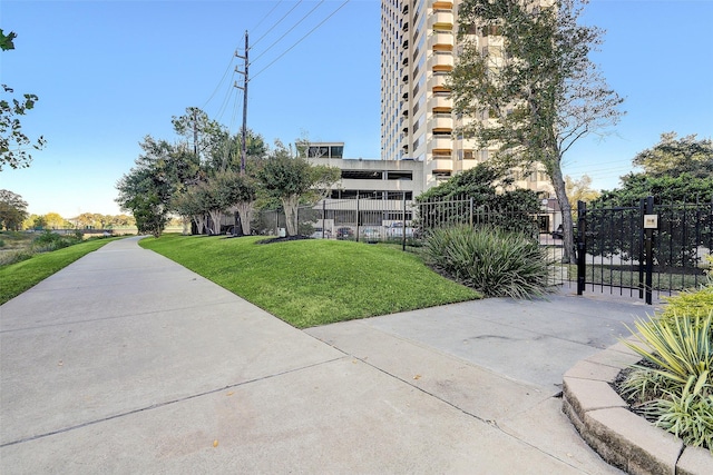 surrounding community featuring fence, a gate, and a yard