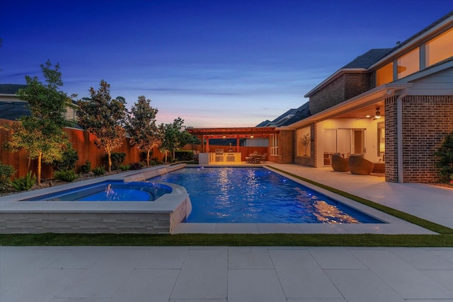 pool at dusk with a fenced backyard, a fenced in pool, an in ground hot tub, and a patio area