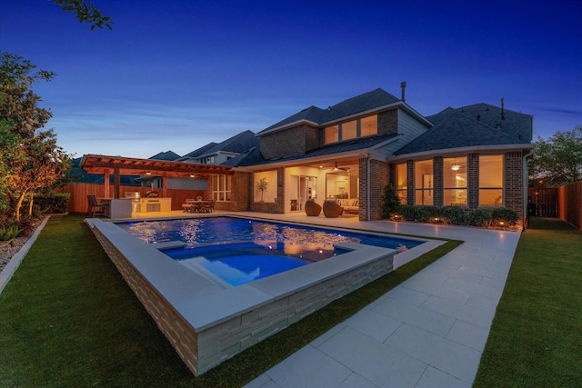 back of property with an in ground hot tub, an outdoor living space, a fenced backyard, and a patio area