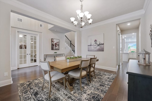 dining area featuring dark wood-style flooring, a notable chandelier, visible vents, ornamental molding, and stairway