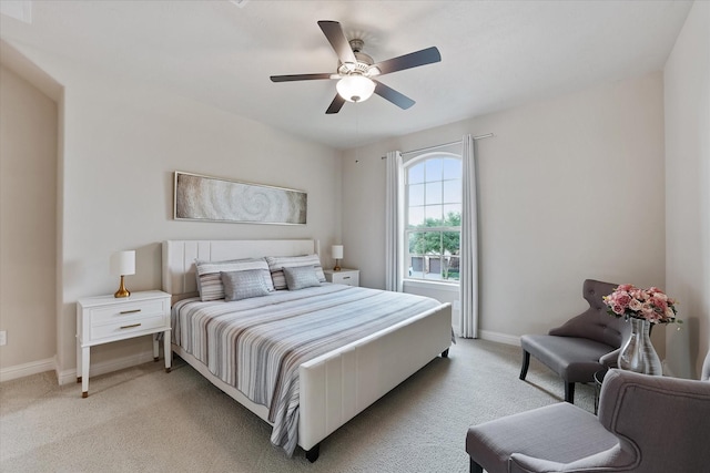 bedroom featuring baseboards, ceiling fan, and light carpet