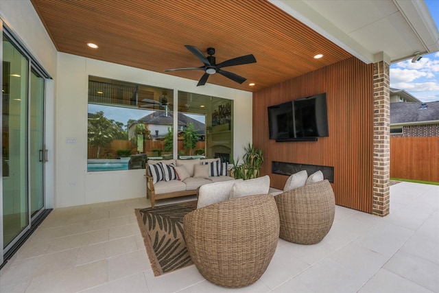view of patio with fence and a ceiling fan