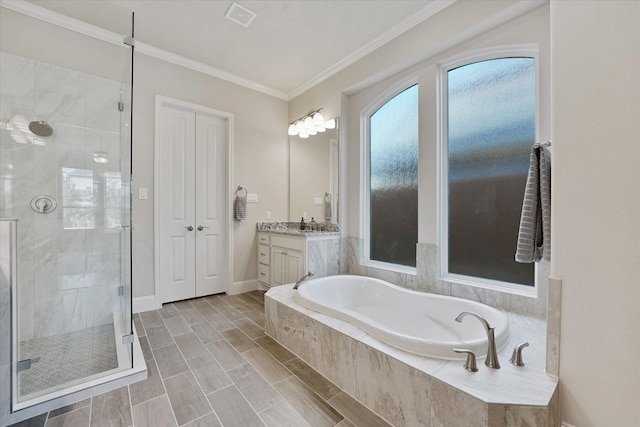 bathroom featuring crown molding, vanity, a shower stall, visible vents, and a garden tub