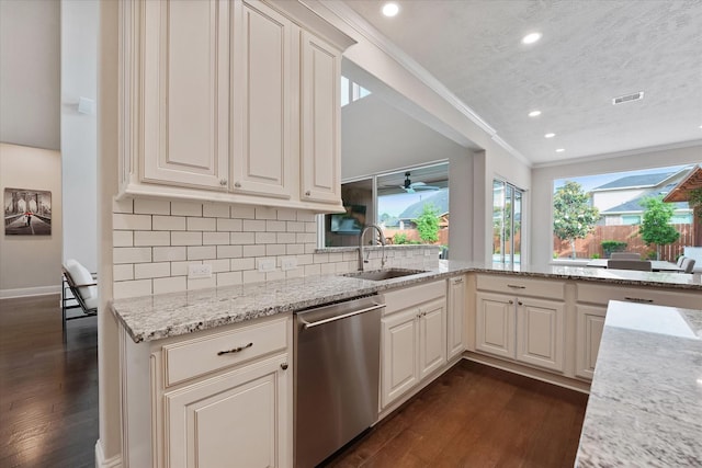 kitchen with dark wood-style flooring, stainless steel dishwasher, light stone countertops, a sink, and recessed lighting